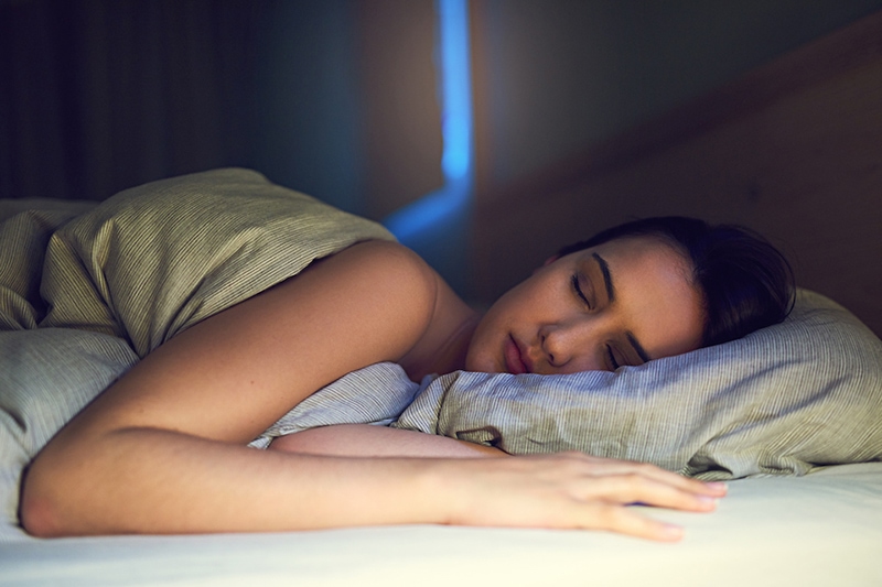 Blog Title: 3 Health Benefits for Using Your AC While Sleeping Photo: woman getting a good night sleep