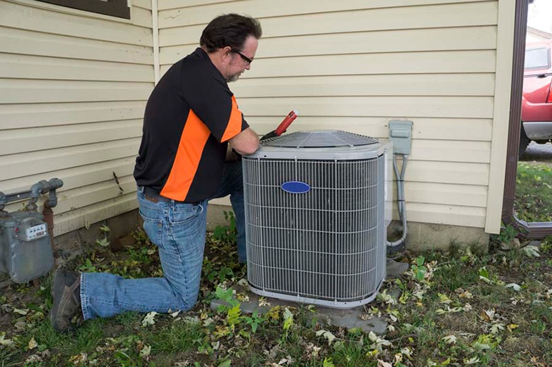 Repairman Checking Outside Air Conditioning Unit For Voltage, Do I Really Need an AC Tune-Up? | HVAC, Maintenance, Repair