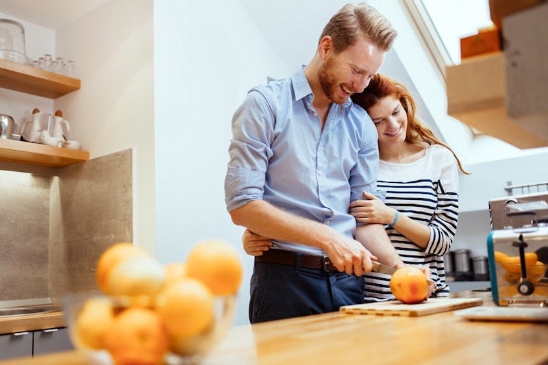 Young couple in the kitchen cutting an orange, Three Reasons to Consider a Geothermal Heat Pump | Wrightsville, PA