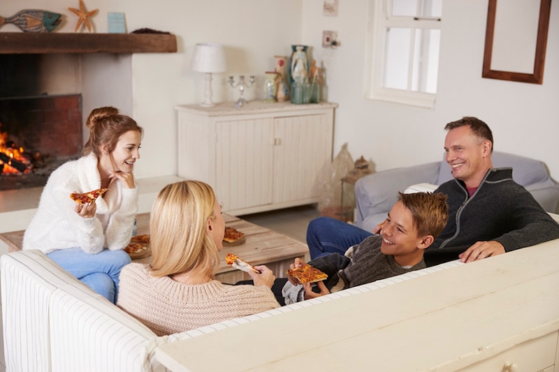 Happy family indoors in their house, How Do I Know When I Need a New Furnace? | Comfortable Design Inc.